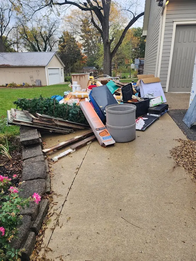 Dumpster being loaded with debris for 12 Yard Dumpster Rental in Mansfield